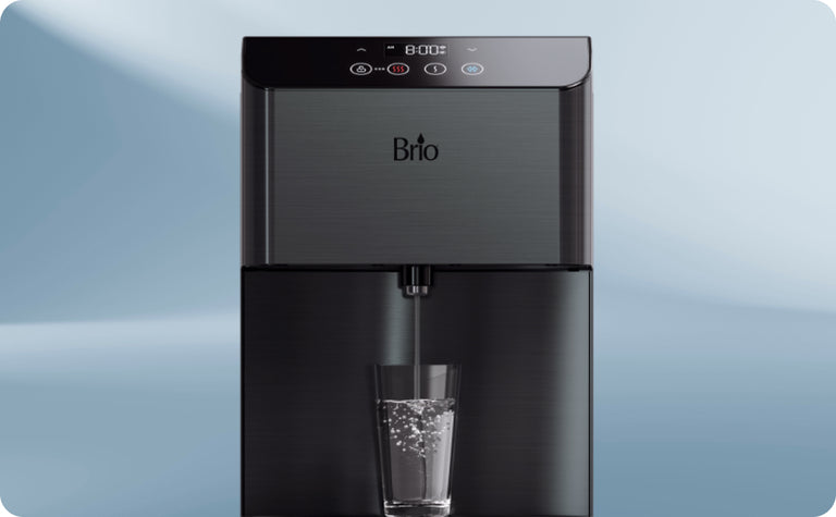 A sleek, black Brio water dispenser dispenses water into a clear glass, with bubbles visible inside the glass. The digital display shows 8002 and has touch control buttons above the dispenser.